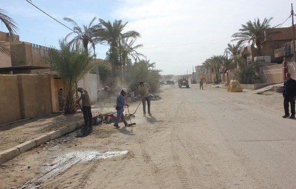 Cleaning crews sweep up debris and remnants of war off the streets of Fallujah. [Saif Ahmed/Diyaruna]