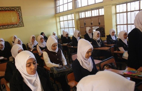 Iraqi students at the Fallujah secondary school for girls attend a history class. Students, especially girls in Fallujah, did not receive any proper education during ISIL's rule of their city. [Saif Ahmed/Diyaruna]
