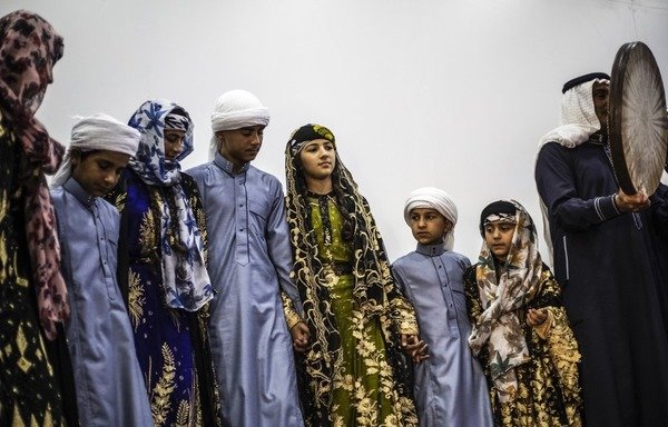 A traditional music and dance group perform at the first cultural and arts centre to open in al-Raqa since the ouster of ISIS from the Syrian city. ISIS had forbidden music and the arts during its rule of al-Raqa. [Delil Souleiman/AFP]