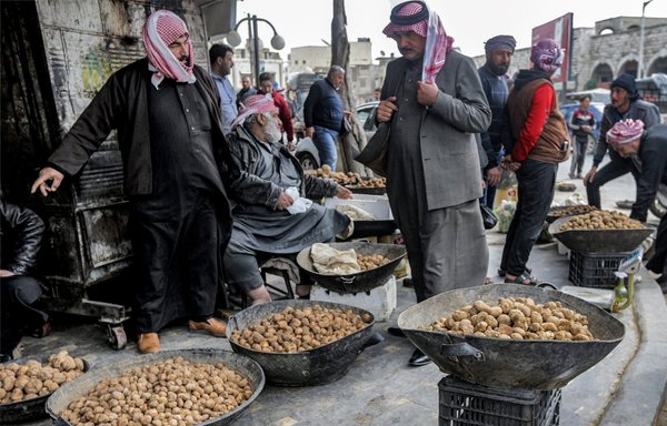 Merchants present their desert truffles at a market in Hama. So far this season, more than 130 truffle hunters have been killed, mostly by extremist attacks and landmines, the Syrian Observatory for Human Rights says. [Louai Beshara/AFP]