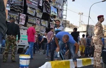 العراق يعوّض العائلات المتضررة من انفجار الكرادة
