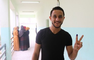 In photos: Anbar residents vote, hope for change
