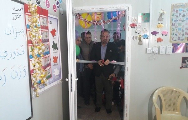 The principal and teachers cut the ribbon to officially open a special needs classroom at the Nubala school in Fallujah. [Saif Ahmed/Diyaruna]