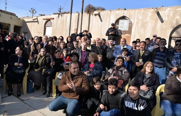 Christian families gather at the Church of St. Saoua during a recent return visit. [Photo courtesy of al-Shabab Radio station in Ramadi]