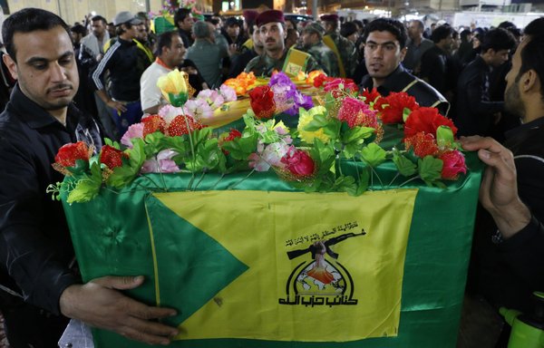 The Iran-backed Kataib Hizbullah militia holds a funeral for its members who were killed in Syria. [Hassan al-Obeidi/Diyaruna]