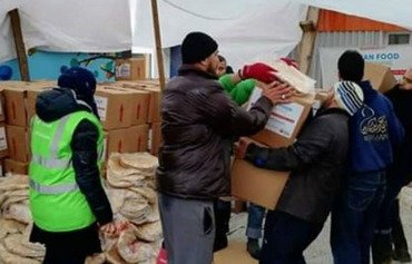 IRGC hands out aid to Syrians as Iranians suffer flooding aftermath