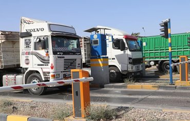 Iraqi truck drivers incur losses due to militias' extortion
