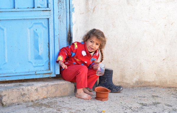 A school-age girl from a Syrian refugee family sits on the doorstep of a home in the Saadnayel area of the Bekaa Valley in autumn 2021. [Ziad Hatem]