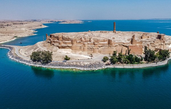 This picture taken on June 3 shows an aerial view of Qalaat Jaabar in Syria's Lake Assad reservoir in al-Raqa province. The ancient lake-side fortress, once used by ISIS to launch attacks, is slowly regaining its status as a top cultural destination, attracting visitors from across Syria. [Delil Souleiman/AFP]
